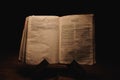 Closeup shot of a historic old Bible open on the Timothy pages on display in a dark room Royalty Free Stock Photo