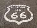 Closeup shot of the historic US route 66 sign in asphalt in Arizona, USA Royalty Free Stock Photo