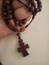 Closeup shot of a holy wooden Christian cross in a hand Royalty Free Stock Photo