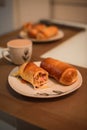 Closeup shot of homemade fresh bread rolls on a plate and a cup of coffee for breakfast Royalty Free Stock Photo