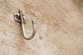 Closeup shot of a hook attached to a concrete wall