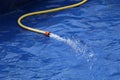 Closeup shot of a hose filling the inflatable pool