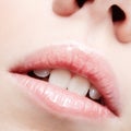 Closeup shot of human female face. Woman with pink plump lips makeup