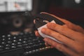 Closeup shot of a human hand cleaning a mouse with a wet wipe Royalty Free Stock Photo