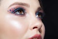 Closeup shot of human woman face. Female with face and eyes beauty makeup with blue eye shadow make up and rhinestones Royalty Free Stock Photo