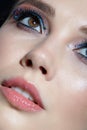 Closeup shot of human woman face. Female with face and eyes beauty makeup with blue eye shadow make up and rhinestones Royalty Free Stock Photo