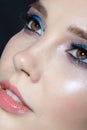 Closeup shot of human woman face. Female with face and eyes beauty makeup with blue eye shadow make up and rhinestones Royalty Free Stock Photo