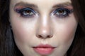 Closeup shot of human woman face. Female with face and eyes beauty makeup with blue eye shadow make up and rhinestones Royalty Free Stock Photo