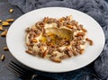 Closeup shot of Hummus with pieces of meat on a white plate, cold appetizer