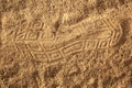 Closeup shot of an imprint of a shoe on a sandy ground