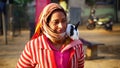 Closeup shot of Indian woman and rabbit on shoulder. Cute rabbit sitting on shoulder and glancing at camera