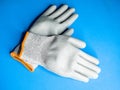 Closeup shot of industrial work gloves on a blue surface Royalty Free Stock Photo