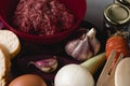 Closeup shot of ingredients for preparing meatballs on a white kitchen table Royalty Free Stock Photo