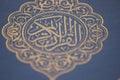 Closeup shot of Islamic Book Quran with golden arabic calligraphy