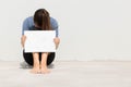 Woman holding blank white sign with her head buried in defeat Royalty Free Stock Photo