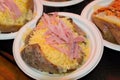 Closeup shot of jacked potatoes in a plastic plate in London, England