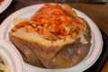 Closeup shot of jacked potatoes in a plastic plate in London, England