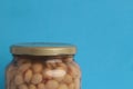 Closeup shot of a jar of dried beans on a blue background Royalty Free Stock Photo