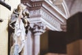 Closeup shot of a Jesus christ figurine whit his hands up and a blurred background