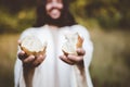 Closeup shot of Jesus Christ handing out bread with a blurred background