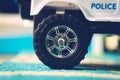 Closeup shot of a kid's toy car wheel on a carpet Royalty Free Stock Photo