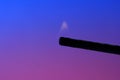 Closeup shot of kitchen lighter with flame isolated on a blue and pink background Royalty Free Stock Photo