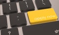 Closeup shot of a laptop keyboard with a yellow apply now button Royalty Free Stock Photo