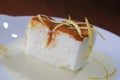 Closeup shot of lemon pie dessert with cajeta and lemon zest sauce on a white plate background