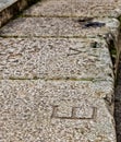 Closeup shot of letters indicating the seats in the bleachers of the Roman Theatre of Merida, Spai Royalty Free Stock Photo