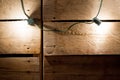 Closeup shot of lit lights hanging with a wooden wall in the background Royalty Free Stock Photo
