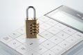 Closeup shot of a lock a calculator on a white surface Royalty Free Stock Photo