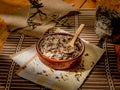 Closeup shot of long grain wild rice in a plate with a wooden spoon on a piece table cover Royalty Free Stock Photo