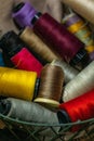 Closeup shot of a lot of colorful yarn rolls in a basket Royalty Free Stock Photo