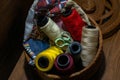 Closeup shot of a lot of colorful yarn rolls in a basket Royalty Free Stock Photo