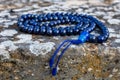 Closeup shot of mala beads on a stone