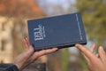 Closeup shot of a male and a female hand holding the Bible Royalty Free Stock Photo