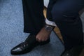 Closeup shot of a male in a formal suit wearing elegant black shoes Royalty Free Stock Photo
