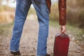 Closeup shot of a male grabbing his old suitcase - concept getting ready to travel Royalty Free Stock Photo