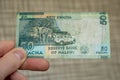 Closeup shot of a male hand holding Malawi 50 kwacha banknote Royalty Free Stock Photo