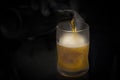 Closeup shot of a male hand pouring a beer into the glass Royalty Free Stock Photo