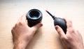 Closeup shot of male hands cleaning a photographic lens