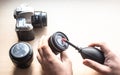 Closeup shot of male hands cleaning a photographic lens