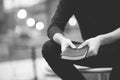 Closeup shot of a male holding the bible with a blurred background in black and white Royalty Free Stock Photo