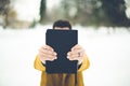 Closeup shot of a male holding the bible towards the camera with a blurred background Royalty Free Stock Photo