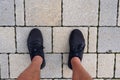 Closeup shot of male legs with black sneakers Royalty Free Stock Photo