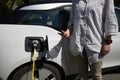 Closeup shot of a male at petrol station filling his car with petrol