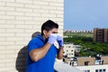 Closeup shot of a male in quarantine on their terrace using protective measures