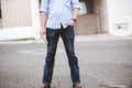 Closeup shot of a male standing with one hand in his pocket and the other holding the bible Royalty Free Stock Photo
