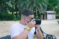 Closeup shot of a male taking a photo wearing a sanitary mask - concept of the new normal