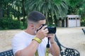 Closeup shot of a male taking a photo wearing a sanitary mask - concept of the new normal